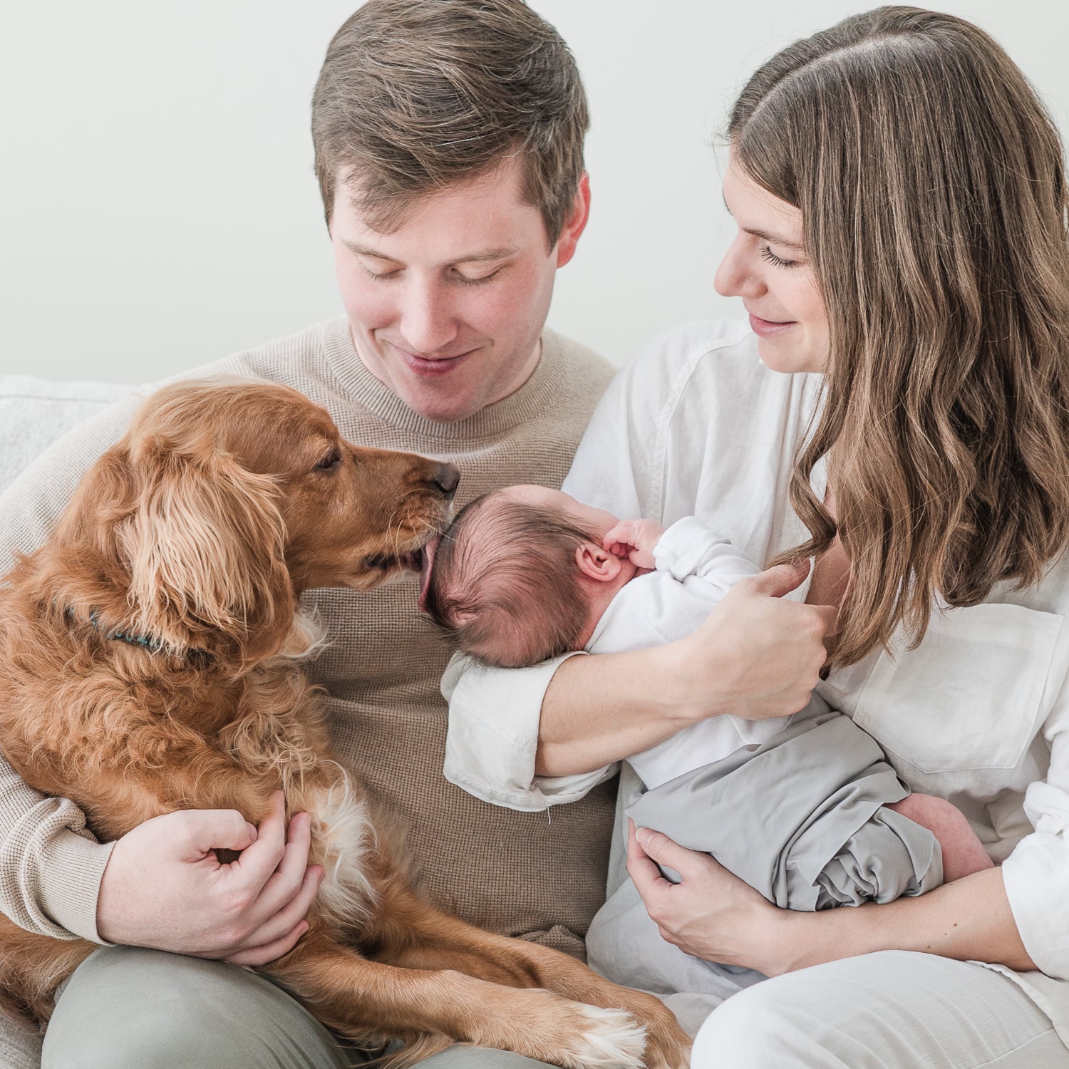 Couple with their newborn and dog